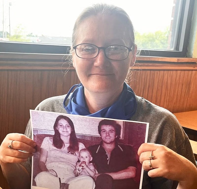 Holly Clouse holding a photo of her parents in 2022